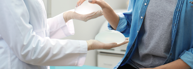 Woman comparing Mentor and Motiva Breast implants in Plastic Surgery consultation